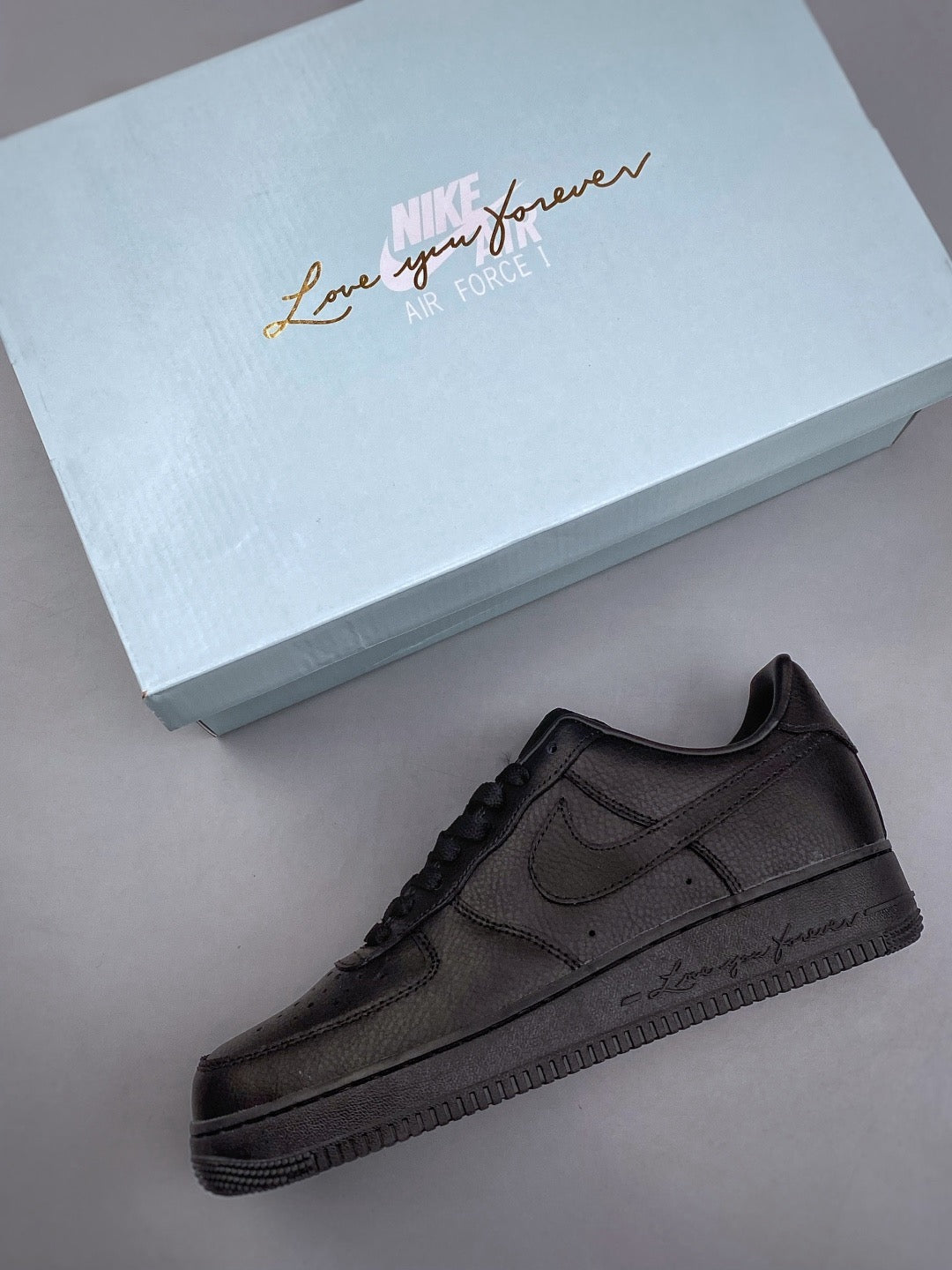 Black low-top sneaker with Love You Forever sole detail, side view