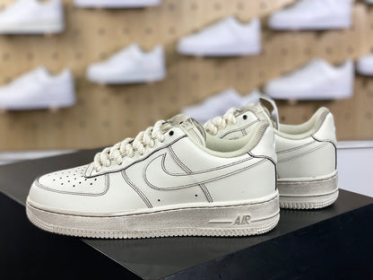 Cream low-top sneakers with rope laces and dark contrast stitching