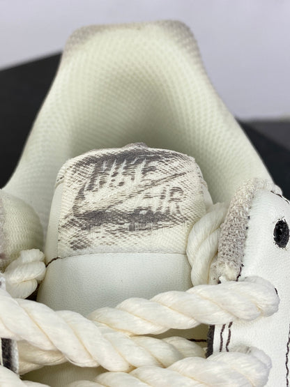 Cream low-top sneakers with rope laces and dark contrast stitching