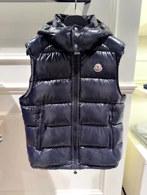 Dark Glossy Hooded Puffer Vest photographed in supplied video